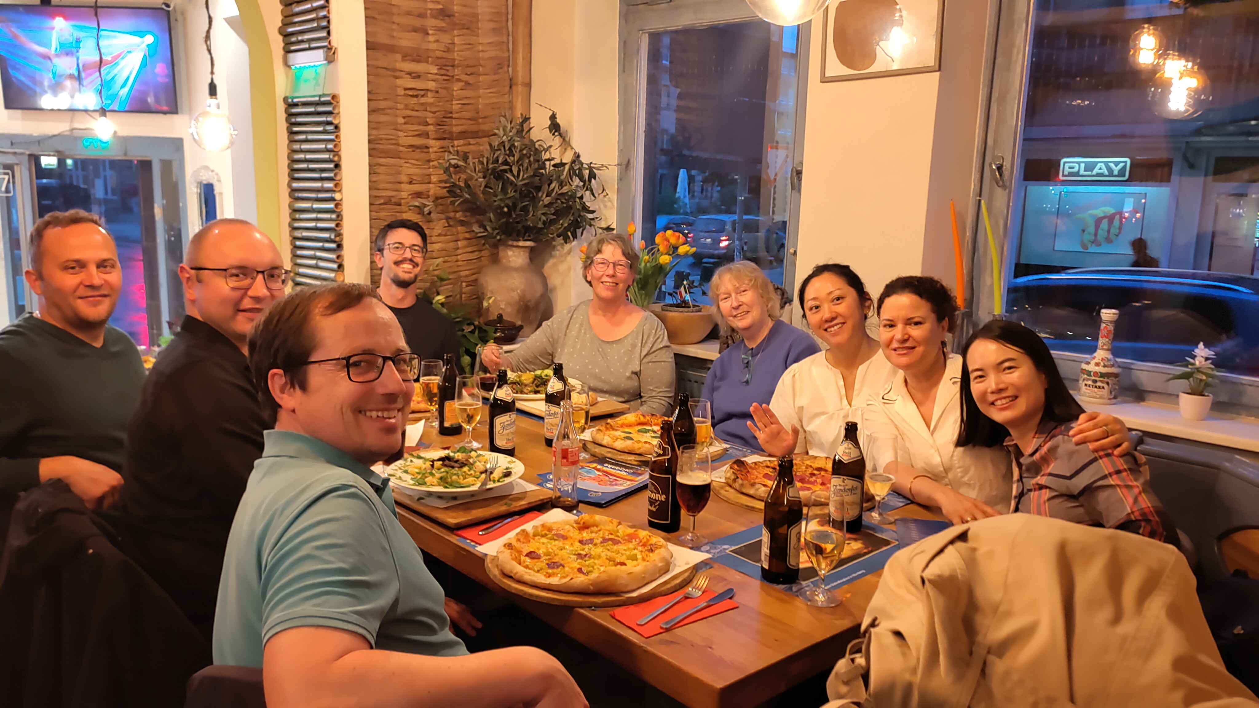 Members and guests socializing over pizza and drinks after the meeting